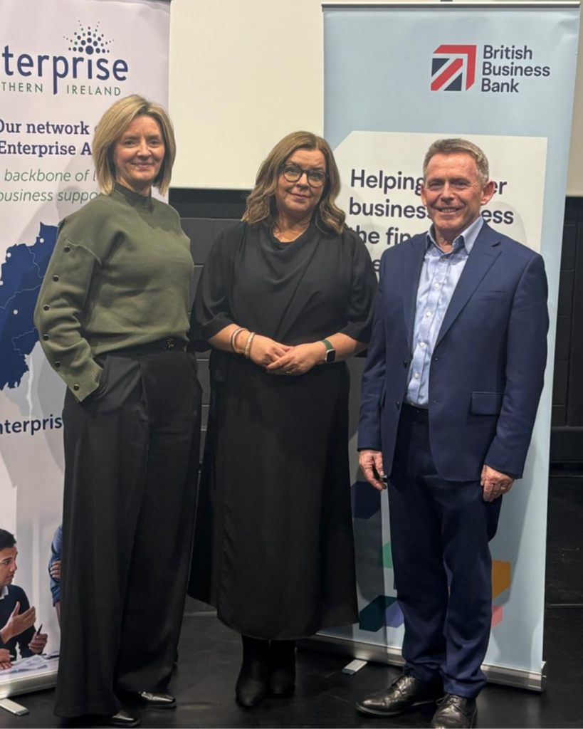 Michael McQuillan from Enterprise Northern Ireland standing beside Susan McKane and Susan Nightingale from British Business Bank for the NI SME Access to Finance Launch in the grand opera house for 2025/2026.